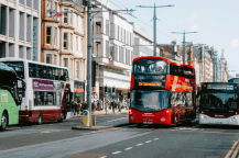 Buses drive down a busy Princes Street in Edinburgh.